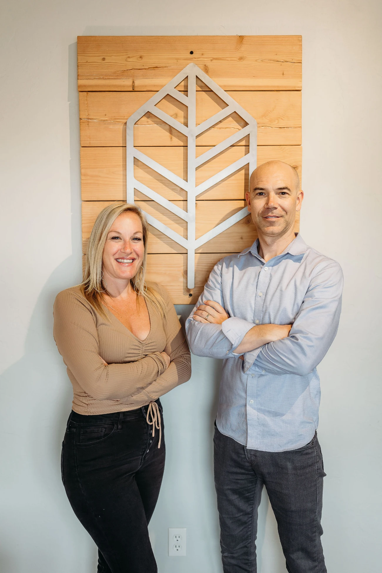 Dr. Jason and Dr. Jessica Bojar standing in front of logo